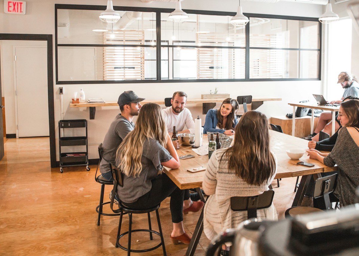 Colleagues in conversation in an open office