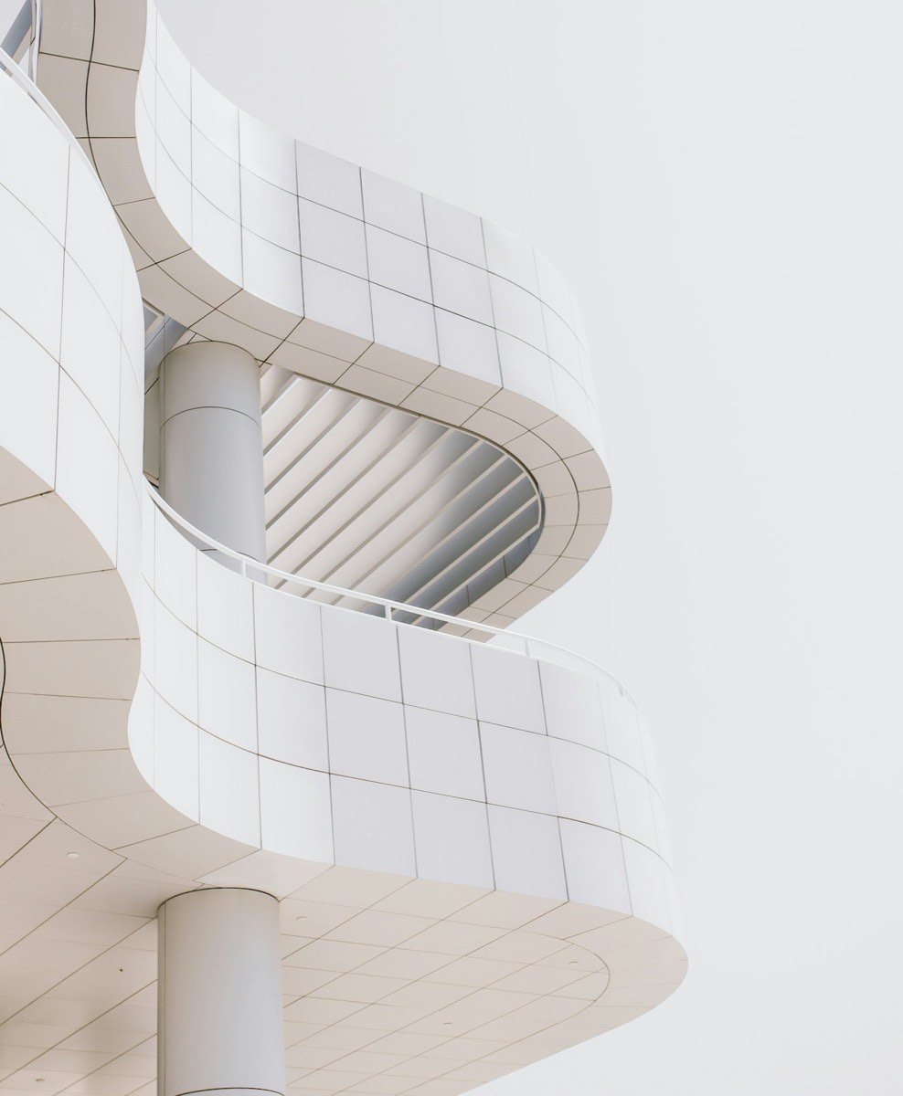 Looking up through a modern concrete building toward the sky